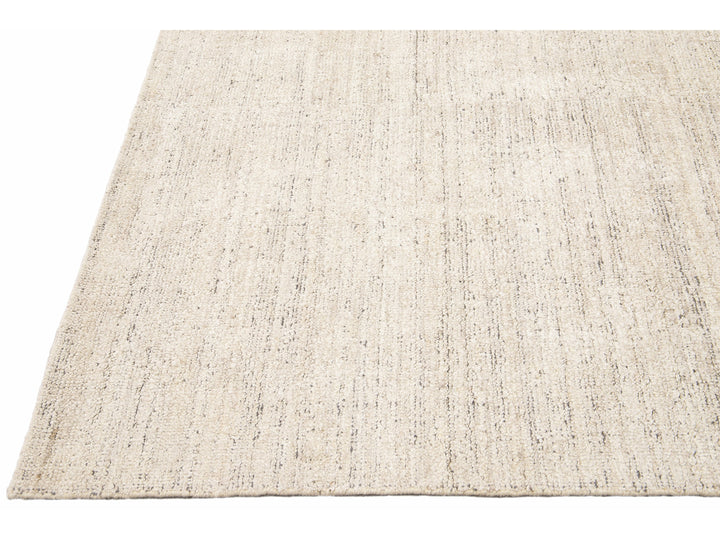 Beautiful Modern Delino hand-loom wool beige field. This piece has a gorgeous all-over solid design.  This rug measures 5' x 8'.