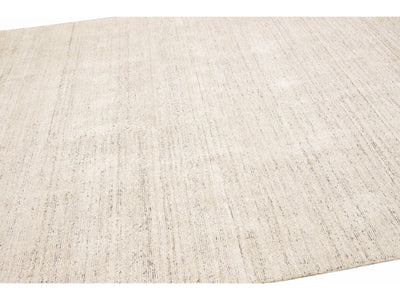 Beautiful Modern Delino hand-loom wool beige field. This piece has a gorgeous all-over solid design.  This rug measures 5' x 8'.  