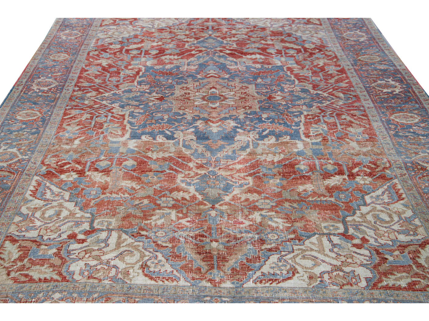 Antique Persian Heriz Handmade Red and Blue Medallion Floral Wool Rug.